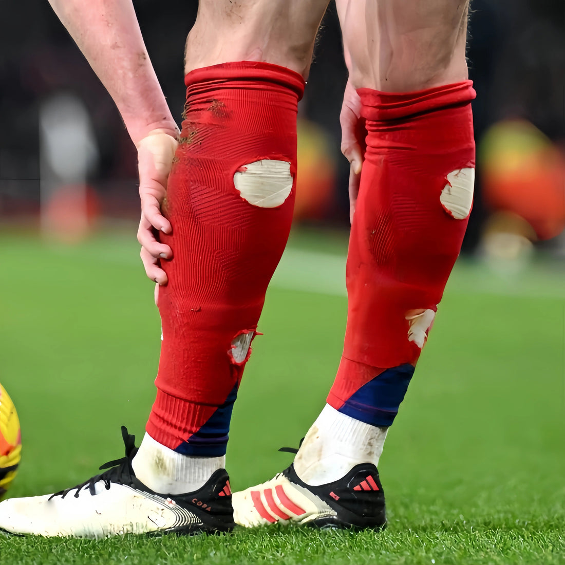 British football player wearing performance football socks on a UK football pitch