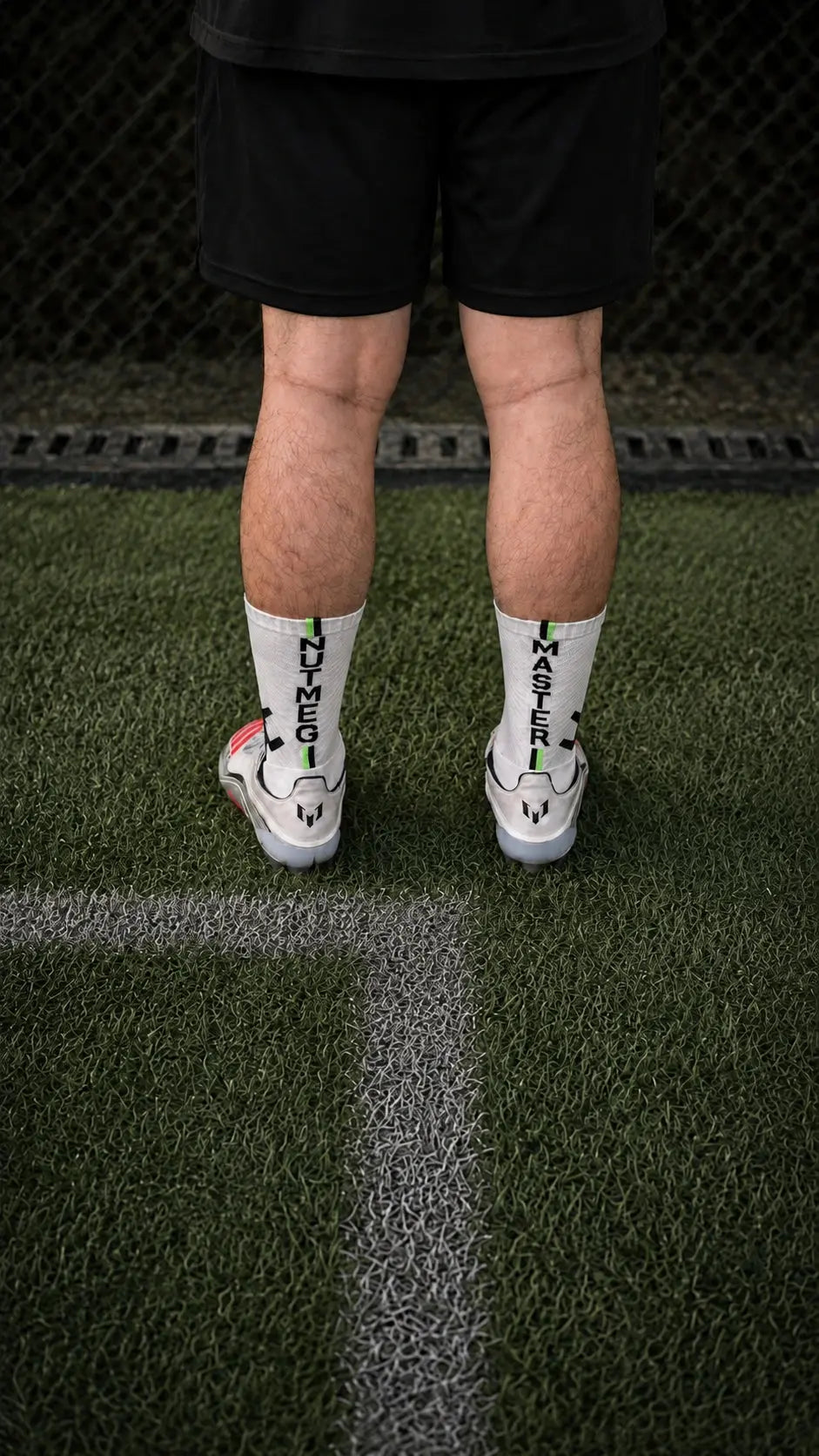 PX GRIP Nutmeg Master football grip socks worn by model on pitch